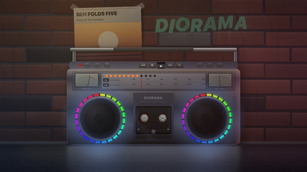 A boombox on the pavement of a brick alley at night, its two speaker rings lit in colour, a poster taped to the wall behind it.